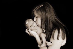 black and white portrait of mom kissing newborn daughter Photo credit Refuge Photography in Frisco, TX