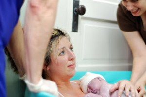 elation, relief, joy and disbelief at holding newborn daughter in birth pool, photo credit Breathtaking Photography