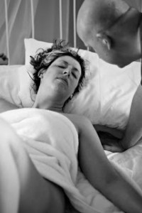 resting in bed in labor, husband checking on wife, photo credit Breathtaking Photography
