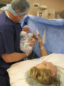 Mommy and Daddy in operating room with baby
