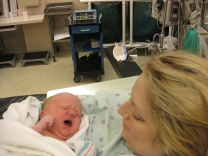 Mom Holding baby for first time in C-section recovery room